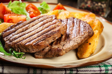 Succulent portions of grilled fillet mignon served with baked potatoes