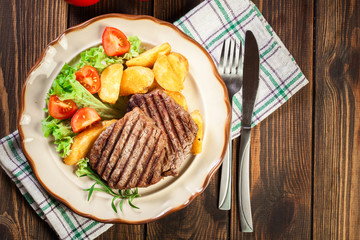Succulent portions of grilled fillet mignon served with baked po
