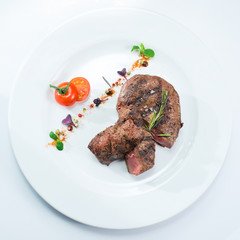 grilled steak on a white plate
