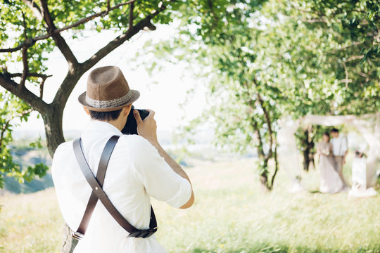 wedding photographer takes pictures of bride and groom in nature, fine art photo