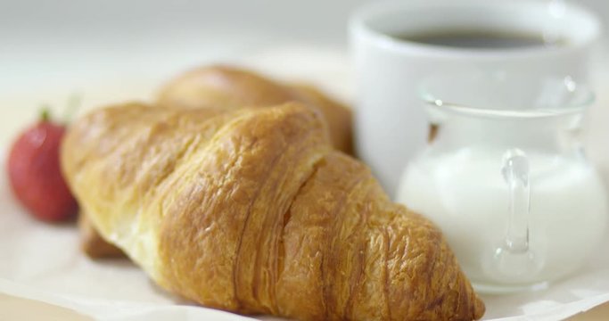 Close-up shot of fresh baked croissants with coffee. 