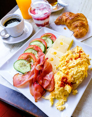 Breakfast with Prepared Egg and salad on table