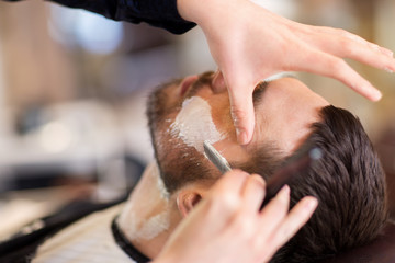man and barber with straight razor shaving beard - obrazy, fototapety, plakaty