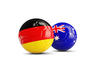 Two footballs with flags of Germany and Australia isolated on white