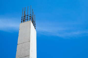 Reinforced concrete column structure in construction site with blue sky background
