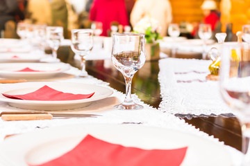 Served dinner table with red napkin in a restaurant. Defocused background