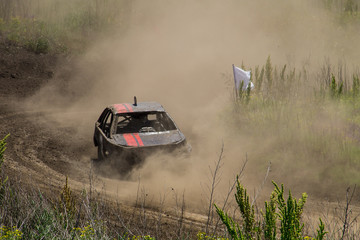 Fototapeta premium Old wrecked cars stock race. Racing in the open air with dust