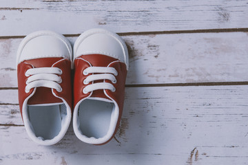 Children shoes on a wood background