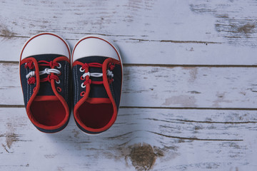 Children shoes on a wood background