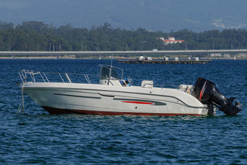 Obraz premium white motor boat at anchor