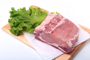 Raw pork chops with herbs and spices on cutting board. Ready for cooking.