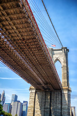 Underside of the Brooklyn Bridge as seen from Brooklyn Bridge Park across the East River from Manhattan.