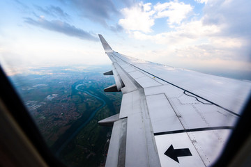 Fototapeta na wymiar Looking trough window of an aircraft, airplane or plane wing.