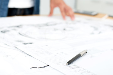 Pen and architectural blueprints on the table