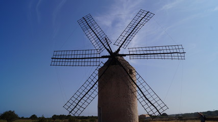 Windmill on Clear Blue Sky Background