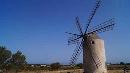 Windmill on Clear Blue Sky Background