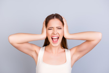 Stop it! Silence! Quiet! Close up of a stressed yelling teen with closed eyes and ears. She is in a...
