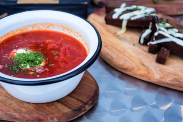Ukrainian borsch soup and green onion on the table