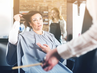 Upset woman in hairdress salon