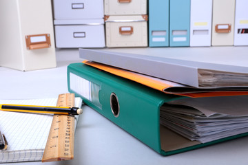 Folder file, note and pen on the desk. blurred background.