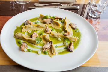 Egg pasta stuffed with mussels and vegetables in the restaurant.