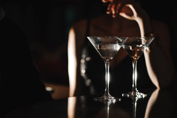 Two glasses of martini coctail in a bar