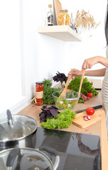 Fresh vegetables on the cutting board, salad in a glass dish. Concept of cooking