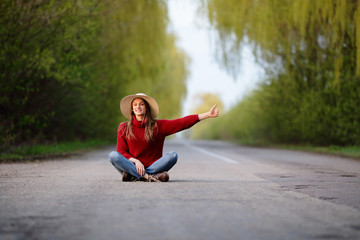 Positive girl sitting on road stopped cars, automatic braking gear, trraveling