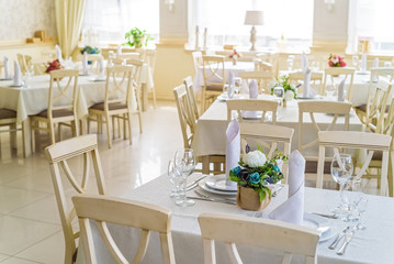 Fototapeta na wymiar Elegant served tables and chairs indoors