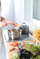 Fresh vegetables on the cutting board, salad in a glass dish. Concept of cooking