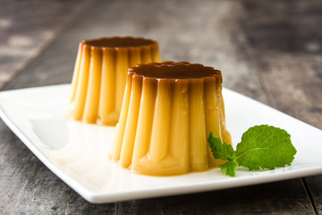 Creme caramel. Egg pudding on wooden table.
