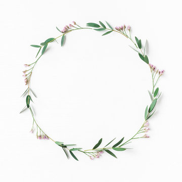 Flowers composition. Wreath made of pink flowers and eucalyptus leaves. Flat lay, top view