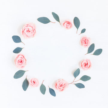 Flowers composition. Wreath made of pink rose flowers and eucalyptus leaves on white background. Flat lay, top view