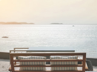 Table set on the beach facing ocean view from very high point of view, showing calm and tranquil...