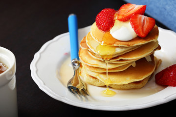 Morning tasty breakfast pancakes with strawberries on white plate, honey, food, fork