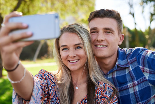 Cute couple taking selfie together in park