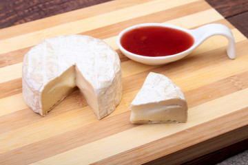 Cheese with white mold. Camembert or brie type with Cranberry sauce.. Healthy breakfast.