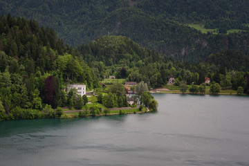Fototapeta na wymiar Bled Lake, shoreline mountain, alpine village in sunny weather, Slovenia, Europe.