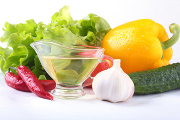 Assorted vegetables, fresh bell pepper, tomato, chilli pepper, cucumber, olive oil, garlic and lettuce isolated on white background. Selective focus.
