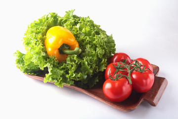 Fresh assorted vegetables bell pepper, tomato, garlic with leaf lettuce. Isolated on white background. Selective focus.