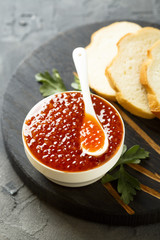 Red caviar in white bowl