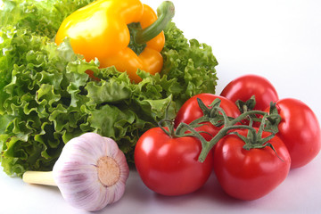 Fresh assorted vegetables bell pepper, tomato, garlic with leaf lettuce. Isolated on white background. Selective focus.