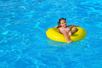 Adorable toddler relaxing in swimming pool