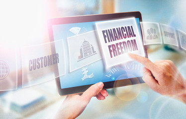 A businesswoman selecting a Financial Freedom business concept on a futuristic portable computer screen.