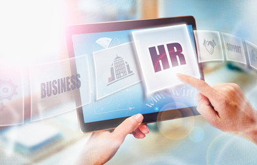 A businesswoman selecting a HR business concept on a futuristic portable computer screen.