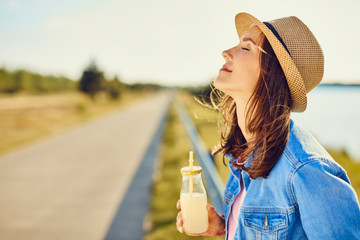 Portrait of young women enjoying summer vacation, drinking lemonade - obrazy, fototapety, plakaty