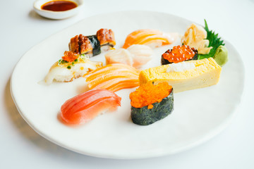 Raw and fresh nigiri sushi set in white plate