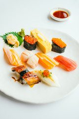 Raw and fresh nigiri sushi set in white plate