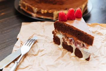 Chocolate truffle cake with cherry in cognac and raspberry