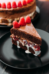 Chocolate truffle cake with cherry in cognac and raspberry